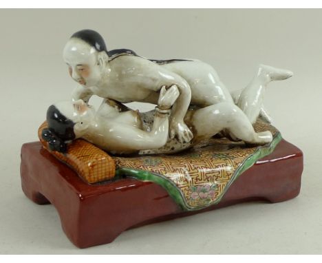 A modern Chinese erotic ceramic sculpture, depicting two lovers in the throes of passion, painted detailing, indistinct stamp