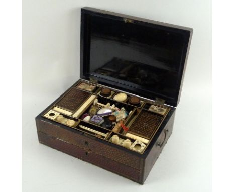 A late 19th century Japanese lacquer and painted workbox with ivory fittings and containing a collection of sewing, needlepoi