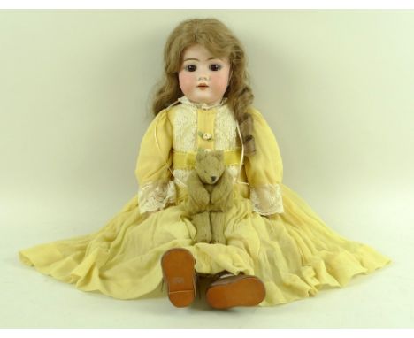 A Max Handwerck bisque headed doll, with weighted brown glass eyes, open mouth and wood and composition ball-jointed body, or