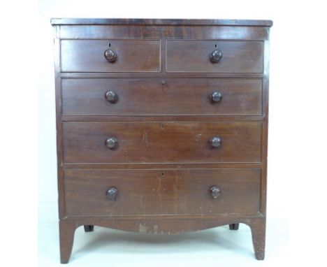 A Regency mahogany flat fronted chest of two short over three long graduating drawers, with turned handles, raised on bracket
