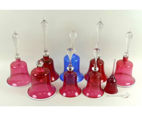 A collection of Victorian and later Bohemian ruby flashed bells, several with wrythen detailing, clear handles, one with blue