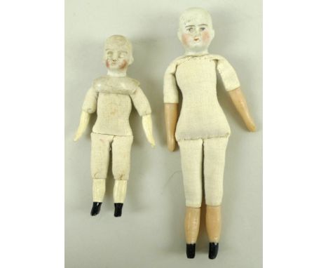 A collection of Victorian and later miniature ceramic doll body parts including arms, legs, heads and torsos, together with a