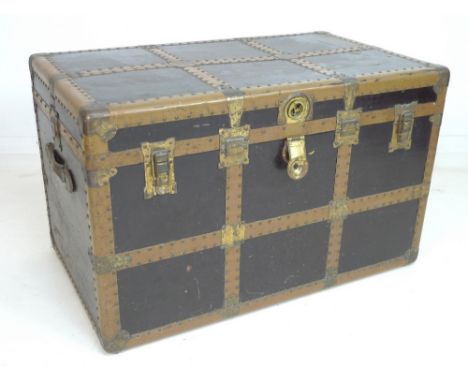 A Victorian copper bound and studded trunk, black painted with brass clasps and leather carry handles, 92 by 50 by 71cm high.