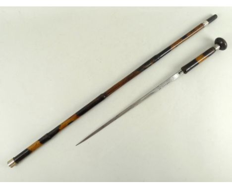A Toledo short bladed sword stick, the cane of bamboo form with deep patina, horn ferrule and flattened circular knop, blade 