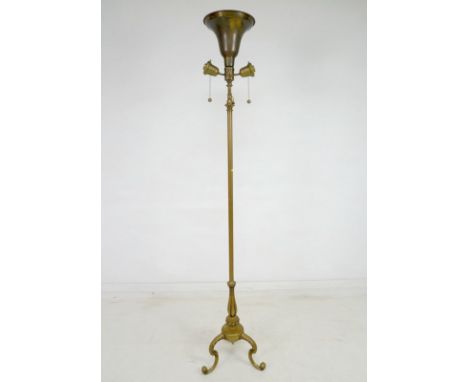 A brass standard lamp, mid 20th century, with uplighter shade, on a lobed tripod base with cabriole legs, 40 by 186cm high.