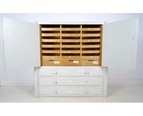 A Dutch 1930's retro chest of three drawers, with glass bottoms to the drawers and white ceramic handles, 121.5 by 57.5 by 12