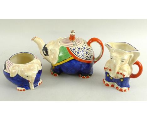 A Royal Venton ware teaset comprising a teapot, milk jug and sucrier, all modelled as elephants, the teapot with monkey finia