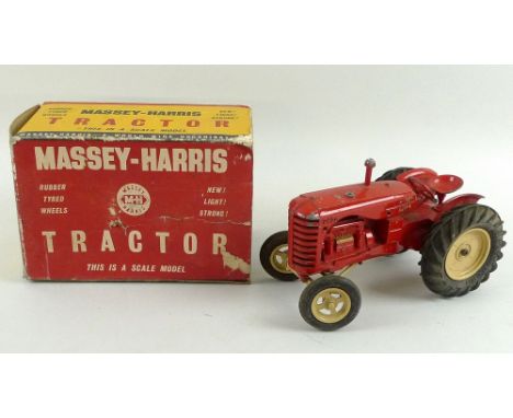 A Massey Harris scale model of a tractor with rubber tyred wheels, the box is worn with one flap missing, 11.5 by 20.5 by 14c