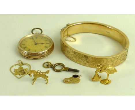 A collection of gold items, comprising a 9ct gold bangle foliate engraved, complete with safety chain, 18.6g, a lady's 9ct go