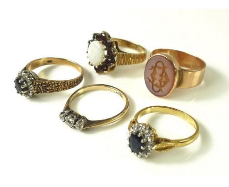 A group of five 9ct gold dress rings, comprising an opal and garnet cluster ring, central opal 9 by 7mm, size N, a diamond th