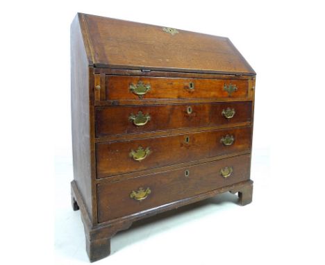 A George III oak bureau, fall front with fitted interior, over four graduating drawers with brass swan neck handles, raised o
