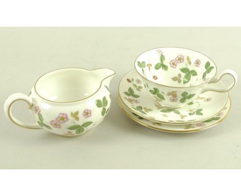 A Wedgwood part tea set, 'Wild Strawberry' pattern, R 4406, comprising four cups, 13 by 5.5cm, two saucers, 14.5cm, one milk 