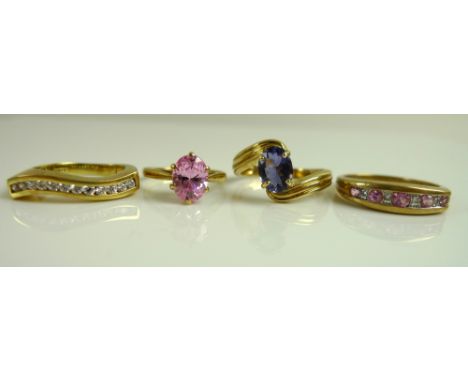 A group of four 9ct gold dress rings comprising an oval cut tanzanite, within a swirl setting, size N, 3g, a pink sapphire an