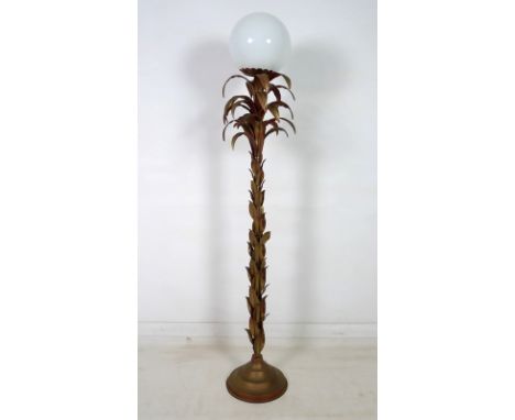 A vintage retro palm tree standard lamp with leaf stem, topped with five layers of palm fronds below a scalloped fitting and 