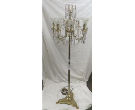 An electric brass chandelier standard lamp, eight branch bulb fittings with etched glass shades and faceted glass pendants, t
