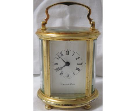 A Mappin and Webb eight day miniature brass carriage clock of oval section, white enamel dial Roman chapter, movement signed 