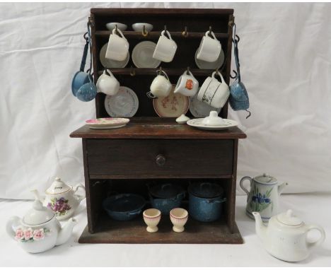 A dolls oak dresser (height 38cm, width 26.5cm) with a small assortment of dolls china and enamel ware
