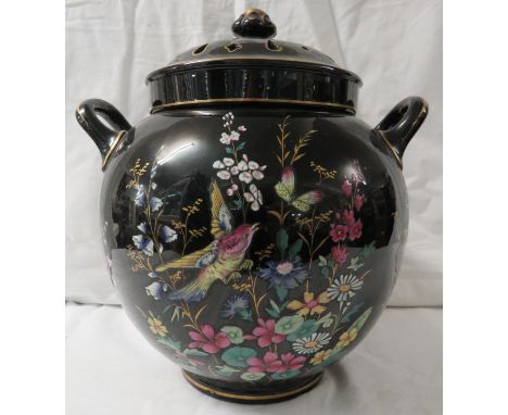 A large ovoid china pot pourri, black ground, transfer and painted enamel decoration of birds amongst flowers in famille rose