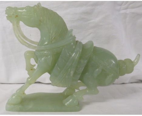 Chinese carved stone figure of a horse with saddle and reins, jade colour and in Tang style, length 21cm, height 15cm