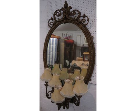 A 19th century girondelle oval wall mirror converted to electricity, five acanthus lamp branches, stained gilt gesso frame wi