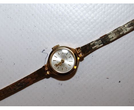 LADY'S 9CT GOLD ROTARY WRISTWATCH GOLD CASE AND BRACELET STRAP SILVERED DIAL WITH BATON MARKERS 