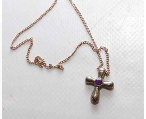 A WHITE METAL CROSS WITH CENTRAL AMETHYST ON CHAIN 