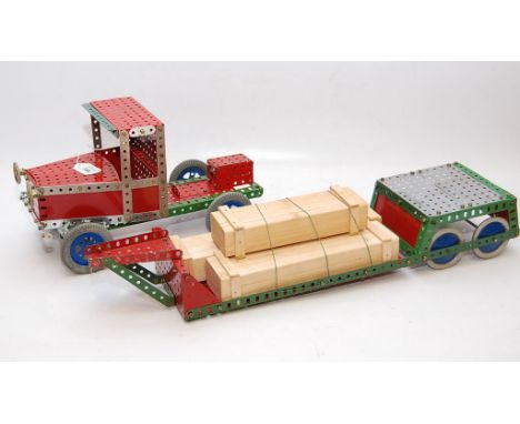 A VINTAGE MECCANO BUILT ARTICULATED LORRY WITH WOODEN CRATES 