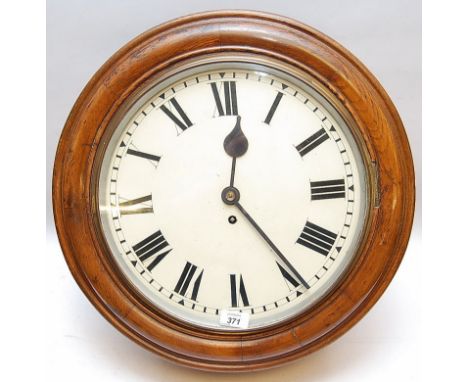 AN EDWARDIAN CIRCULAR PUBLIC BUILDING WALL CLOCK THE FUSEE MOVEMENT TO AN ENAMEL DIAL WITH ROMAN NUMERALS, WITHIN AN OAK CASE