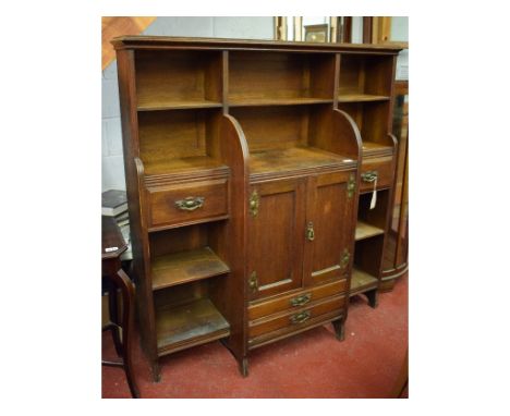 A mid-20th century bookcase, with an arrangement of four drawers and a central cupboard, 122 cm wide x 132 cm high x 37 cm de