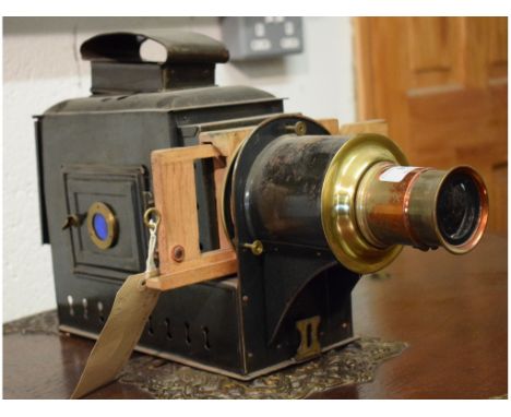 A black lacquered and brass magic lantern, 28 cm high