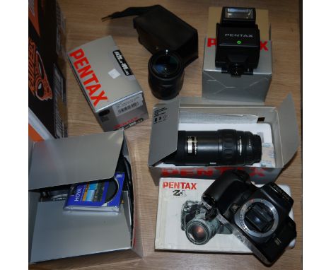 A Pentax Z1 camera with 28-105 mm and 100-300 mm lenses and accessories