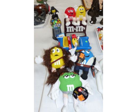 A ceramic M & M advertising car, an M & M advertising cinema figure, a ceramic M & M figure, 3 Star Wars themed M & M plush d