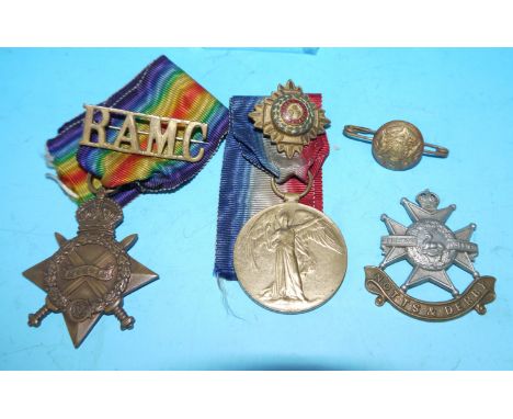 Two WWI medals 1232 Pte R Dunkerley Man Reg; a Notts & Derby cap badge; etc.