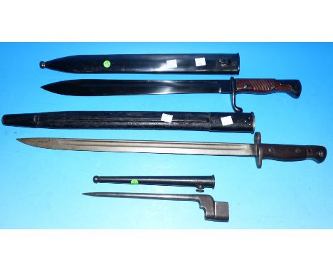 An early 20th century British bayonet with scabbard; a stiletto bayonet; a replica bayonet