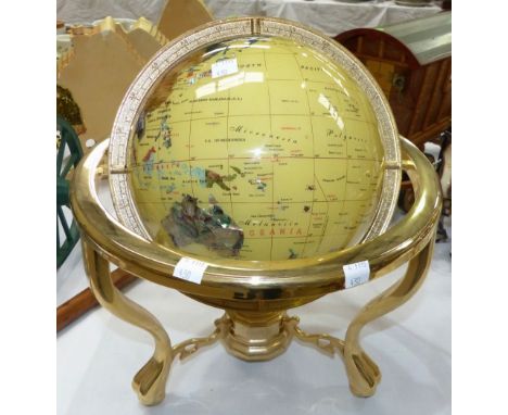 A modern ceramic table top globe on gimbal stand