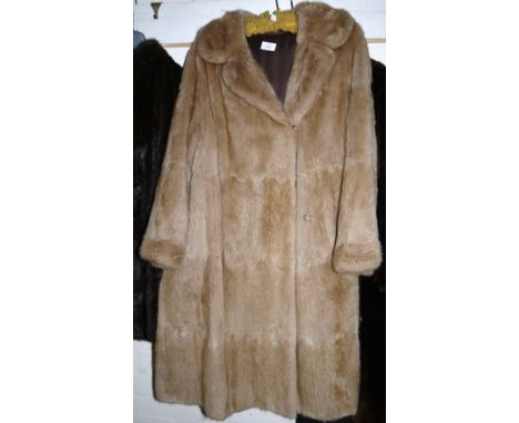 A musquash fur full length coat; a faux fur coat