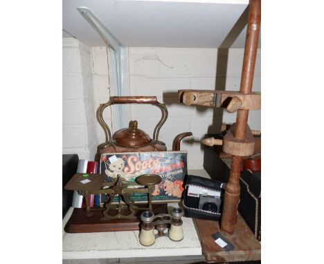A set of brass postage scales and weights; a copper kettle; a pair of opera glasses; an Instamatic camera; a wooden stand; a 