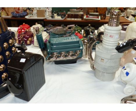 Three modern novelty teapots:  "T8 Turbo" Bentley engine block; J & G Morten Rolls Royce radiator; Total Teapots "Firing on A