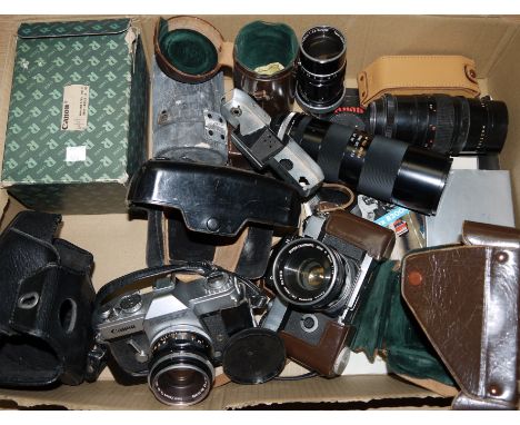 A Canon Canonflex 35mm SLR camera with 50mm f1.8 lens, ER case, a Canon Pellix similar, a Canon 135mm f3.5 lens and other acc