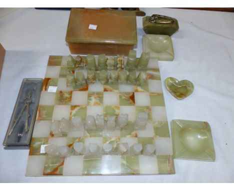 An onyx chessboard; a chess set; other polished stone items