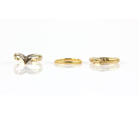 Three rings, one 1930's wedding band, in 22 ct yellow gold, size M, an antique buckle ring, testing as 18 ct, size N 1/2 and 