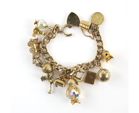 Vintage gold charm bracelet with fourteen charms, including an ornately engraved globe locket, articulated windmill, train, S