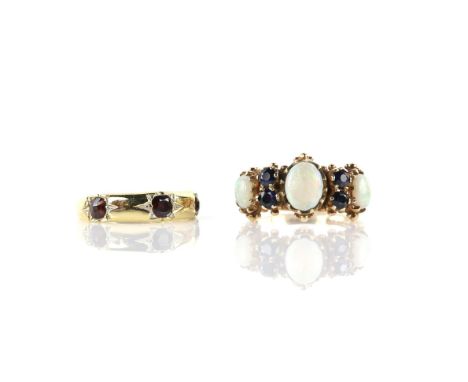 Opal and sapphire ring, set with three oval cabochon cut opals and four round cut sapphires, mounted in 9 ct yellow gold, rin