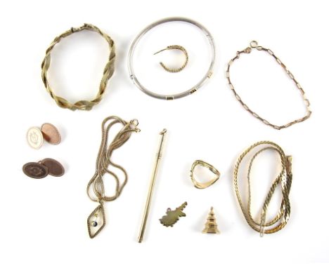 A group of gold items, including a bi -coloured bangle stamped 18 ct, a pair of 1920's monogramed cufflinks, gold swizzle sti