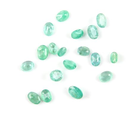 Packet of eighteen oval cut emeralds, largest estimated at 1.95 carats, another similar estimated at 1.66 carats, smallest em