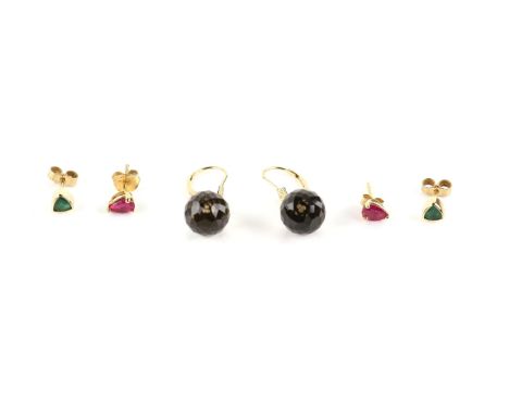 Three pairs of gem set earrings, including a pair of smokey quartz drops, and a pair of trilliant cut emerald stud earrings, 