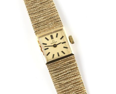Omega, A Ladies reference 1061 gold dress watch the silvered signed dial of square outline fitted with baton hour markers and