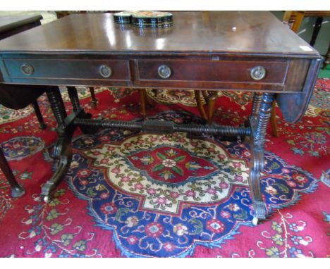 A Regency Mahogany Sofa Table,Having twin frieze drawers, bobbin supports & brass toe castors