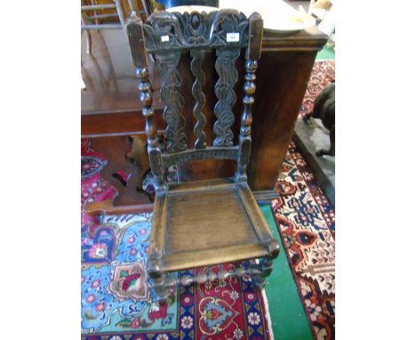Antique Oak High Back Hall Chair having a carved crest rail and triple lath back, hard seat and standing on turned supports u