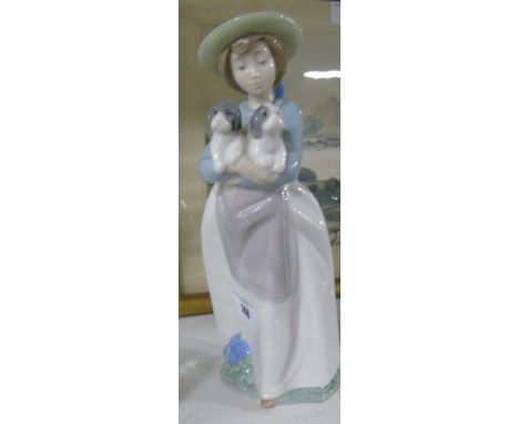 A Nao Figure of a Girl Holding Puppies